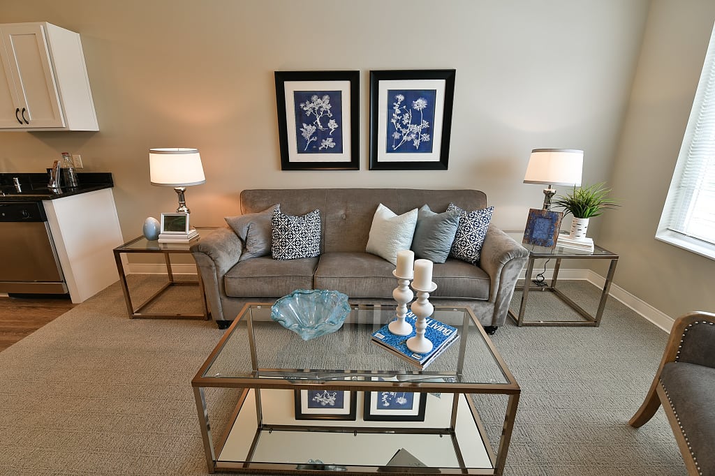 Cozy living room with couch, tables, and various blue decor.