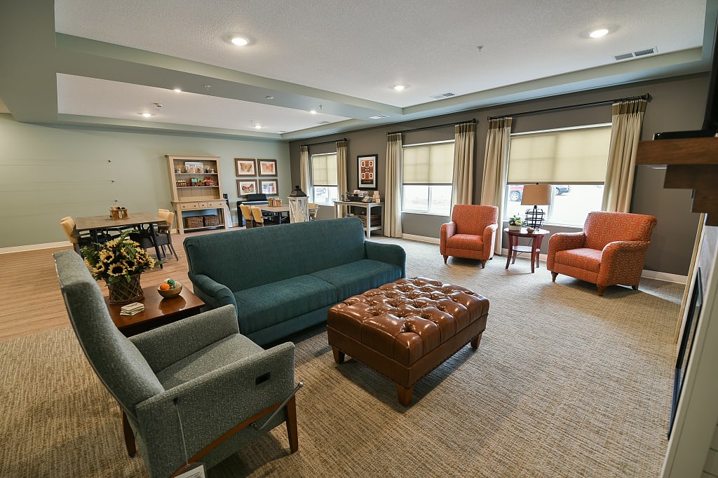 Open common living area with comfortable couches, tables, and chairs