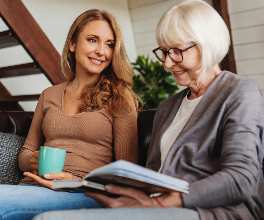 Senior woman sitting with her adult daughter
